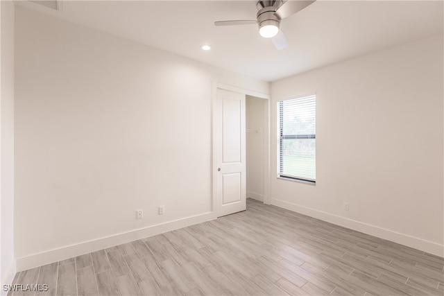 spare room featuring ceiling fan and light wood-type flooring