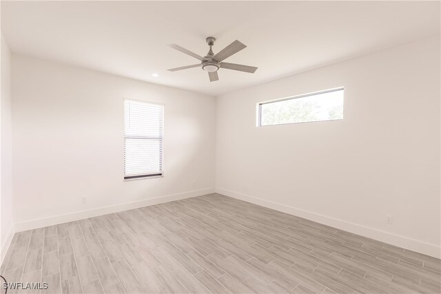 empty room with light hardwood / wood-style flooring and ceiling fan