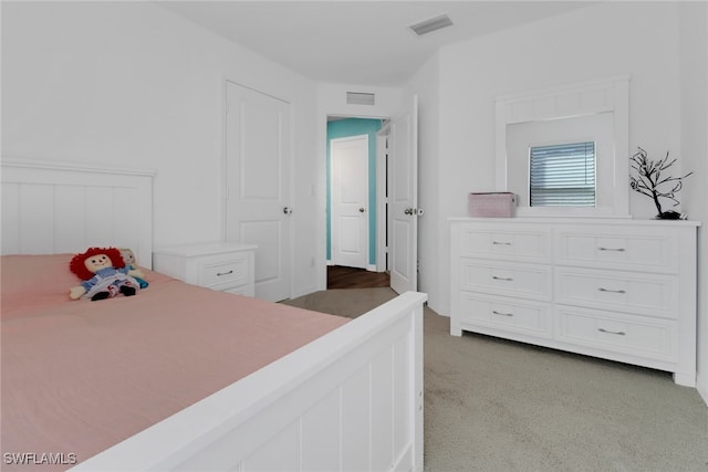 bedroom featuring light carpet