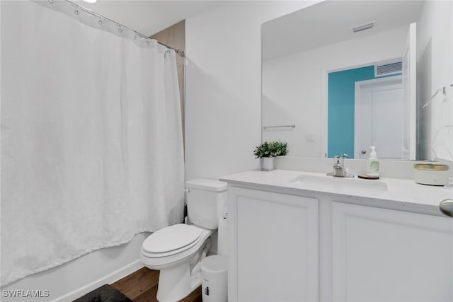 full bathroom with vanity, toilet, wood-type flooring, and shower / tub combo