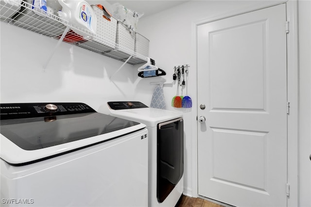 washroom featuring washer and clothes dryer and hardwood / wood-style flooring