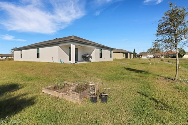 rear view of house with a lawn