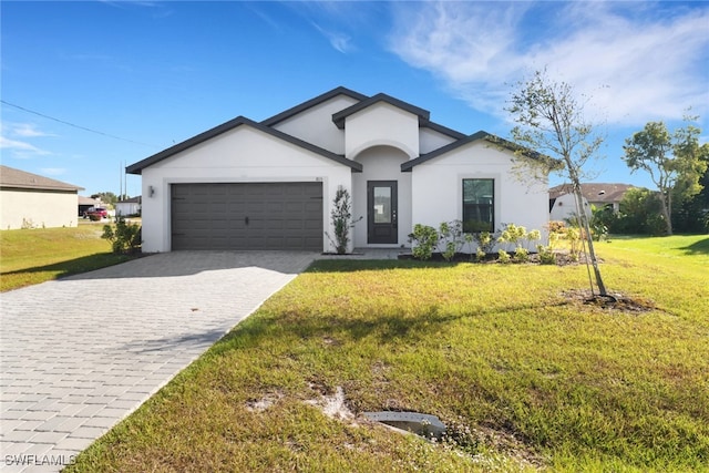 view of front of home with a front yard and a garage