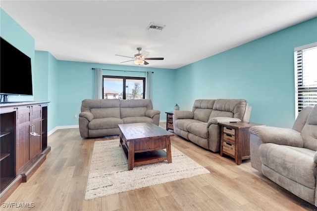 living room with ceiling fan and light hardwood / wood-style floors