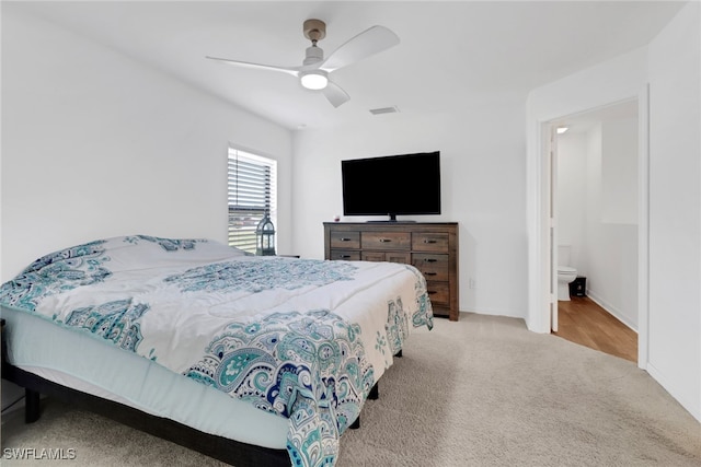 carpeted bedroom with connected bathroom and ceiling fan