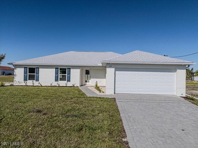 single story home featuring a front lawn and a garage