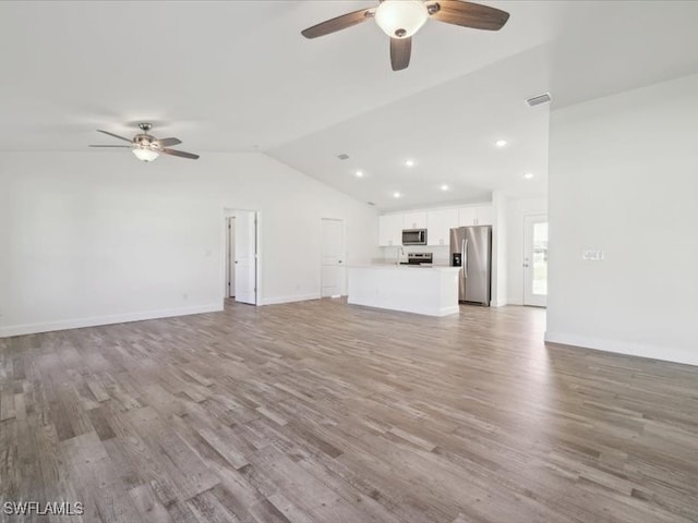 unfurnished living room with ceiling fan, light hardwood / wood-style floors, and lofted ceiling