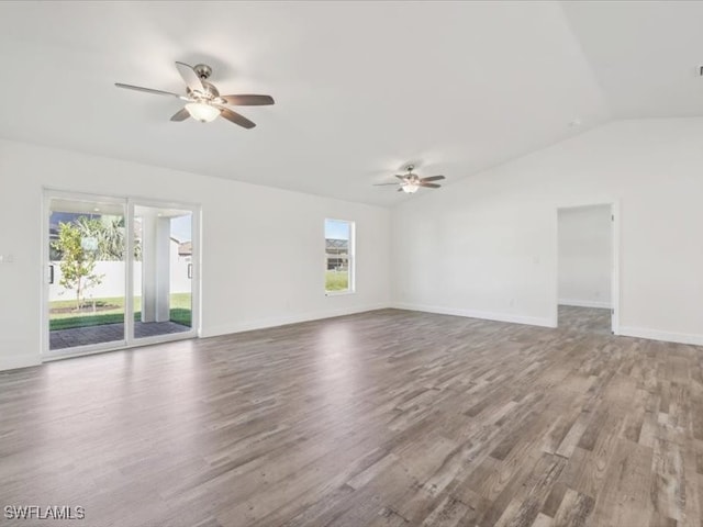 spare room featuring hardwood / wood-style floors, vaulted ceiling, and ceiling fan