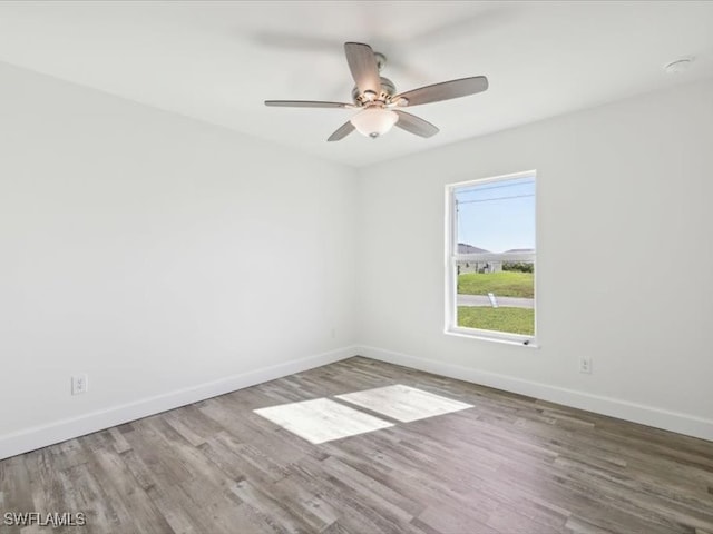 empty room with hardwood / wood-style flooring and ceiling fan