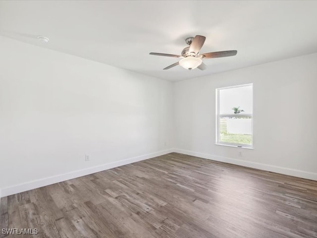 empty room with hardwood / wood-style floors and ceiling fan