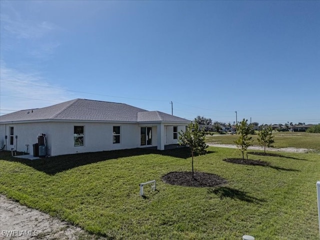 view of side of home featuring a yard