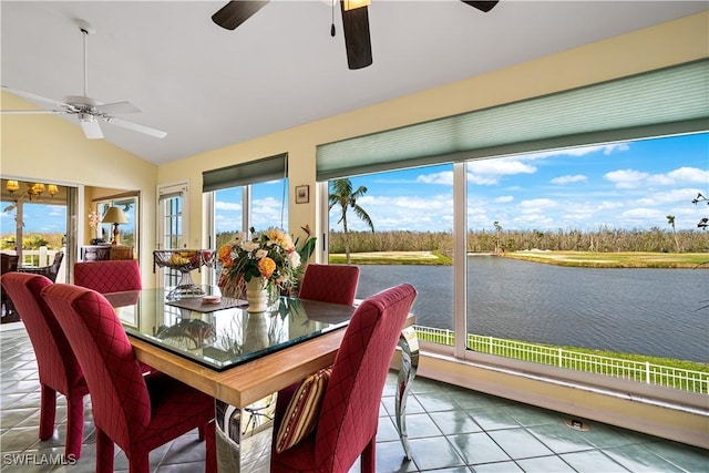 sunroom / solarium featuring a water view, ceiling fan, and vaulted ceiling