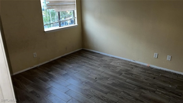 unfurnished room with dark hardwood / wood-style floors