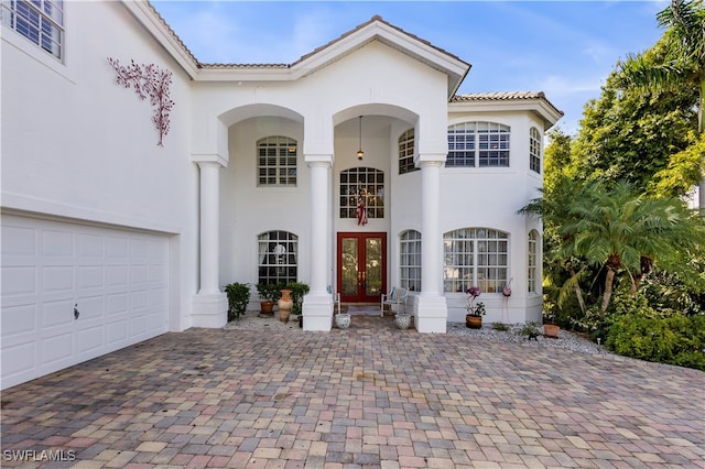 mediterranean / spanish home featuring french doors and a garage