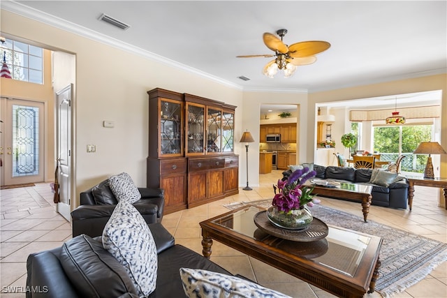 living room with ceiling fan, light tile patterned floors, and crown molding