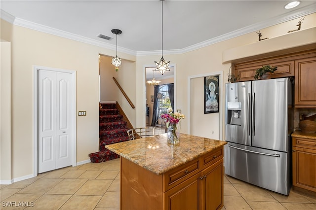 kitchen featuring a kitchen island, ornamental molding, stainless steel refrigerator with ice dispenser, and hanging light fixtures