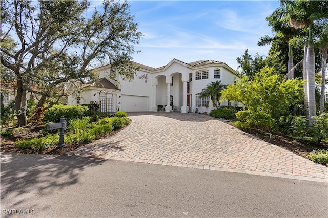 mediterranean / spanish-style home with a garage