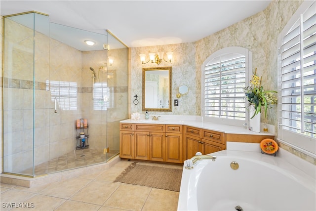 bathroom with shower with separate bathtub, vanity, and tile patterned floors