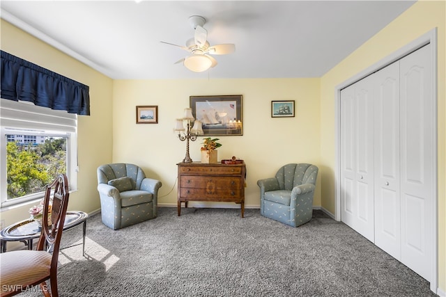 sitting room featuring ceiling fan and carpet