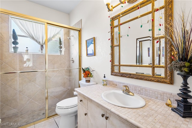 bathroom with tile patterned flooring, vanity, toilet, and a shower with door