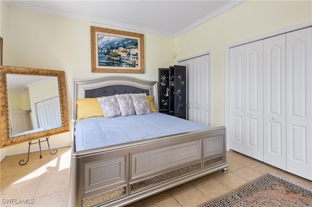 tiled bedroom with two closets and crown molding