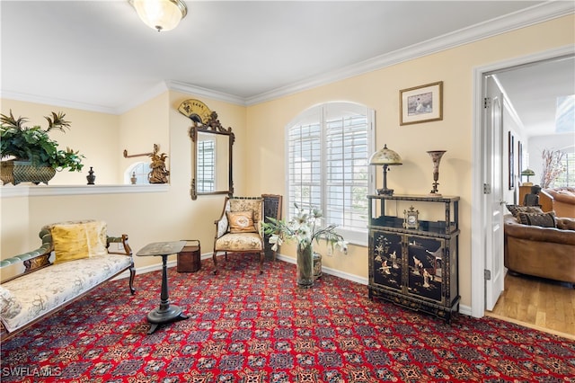 sitting room with hardwood / wood-style flooring and ornamental molding