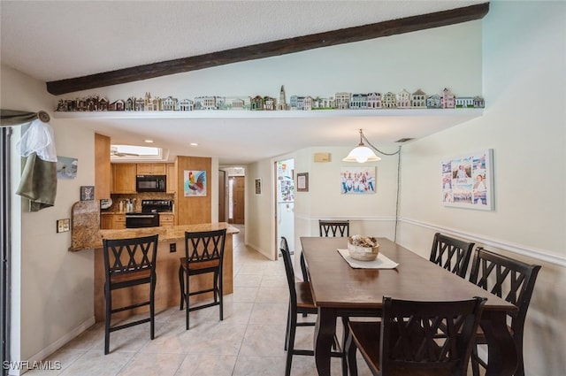 dining room featuring light tile patterned floors and lofted ceiling with beams