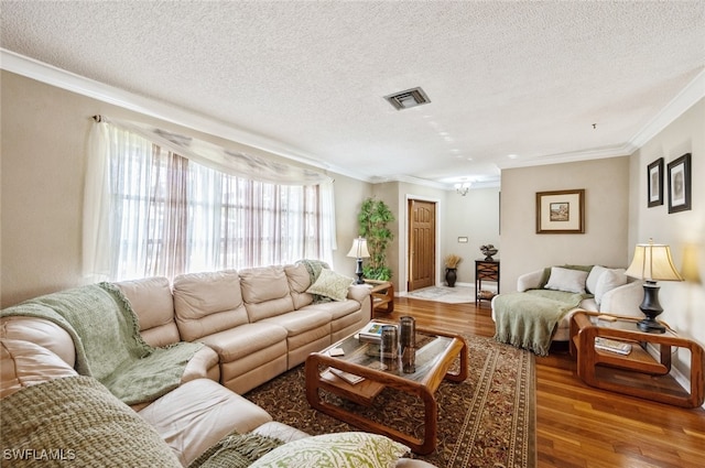 living room with a textured ceiling, light hardwood / wood-style flooring, and ornamental molding