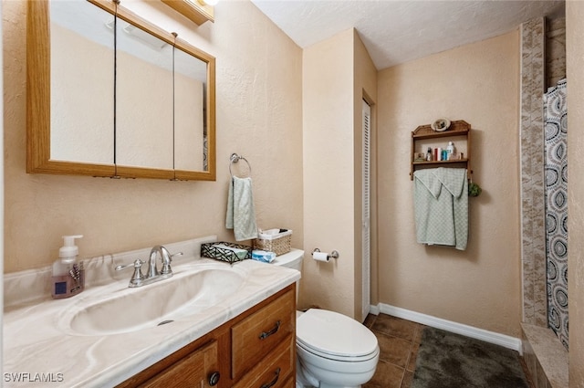 bathroom with tile patterned floors, a textured ceiling, vanity, a shower, and toilet