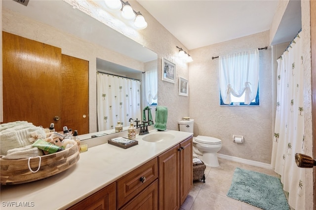 bathroom featuring toilet, vanity, and tile patterned floors