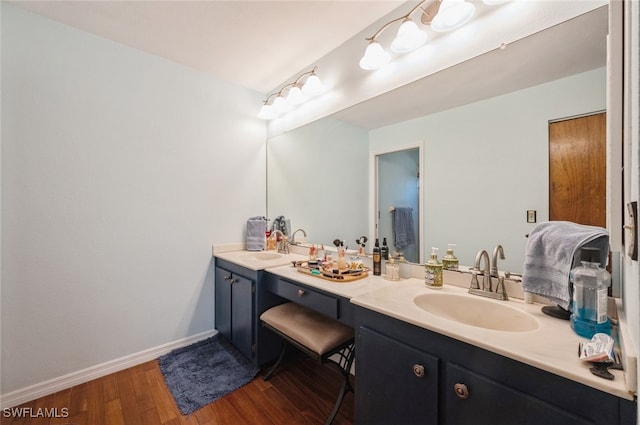 bathroom with vanity and hardwood / wood-style flooring