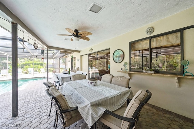 interior space featuring ceiling fan and a pool