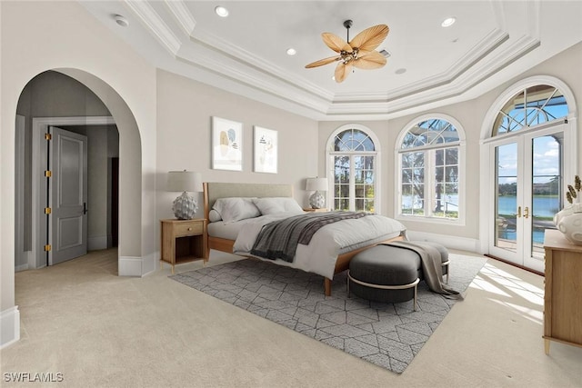 28790 Blaisdell Dr, Naples, FL 34119 - bedroom with light carpet, a tray ceiling, access to outside, multiple windows, and crown molding