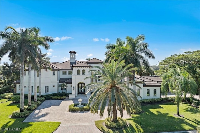 28790 Blaisdell Dr, Naples, FL 34119 - mediterranean / spanish-style house featuring stucco siding, decorative driveway, a front yard, and french doors