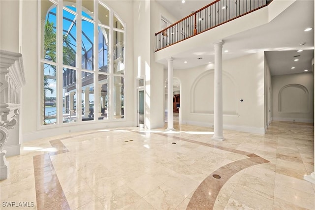 28790 Blaisdell Dr, Naples, FL 34119 - foyer entrance with a towering ceiling, ornate columns, marble tiled floors, inlaid floor details, and baseboards