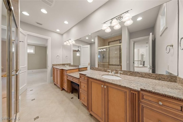 28790 Blaisdell Dr, Naples, FL 34119 - bathroom with a stall shower, two vanities, tile patterned floors, baseboards, and recessed lighting