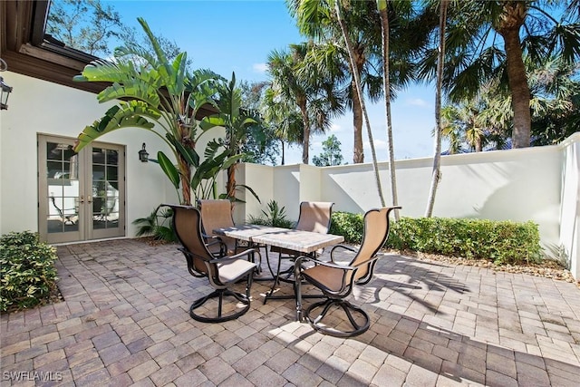 28790 Blaisdell Dr, Naples, FL 34119 - fenced backyard featuring french doors, a patio, and outdoor dining area
