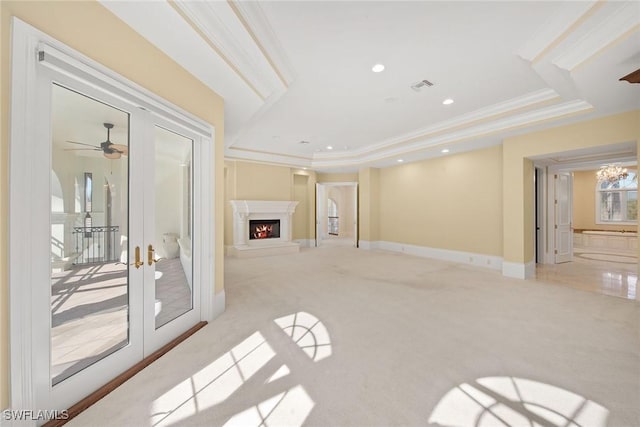 28790 Blaisdell Dr, Naples, FL 34119 - unfurnished living room featuring crown molding, french doors, light carpet, a warm lit fireplace, and recessed lighting