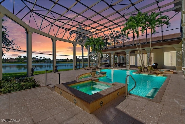 28790 Blaisdell Dr, Naples, FL 34119 - pool at dusk featuring a patio, a water view, and a pool with connected hot tub