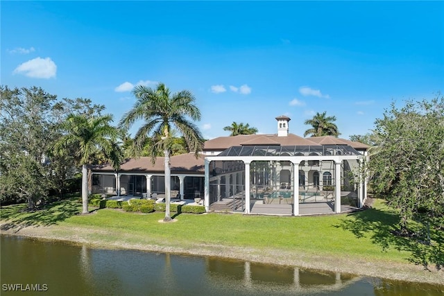 28790 Blaisdell Dr, Naples, FL 34119 - back of property with a water view, a patio, an outdoor pool, and a lawn