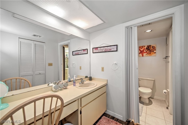 bathroom with tile patterned floors, vanity, and toilet