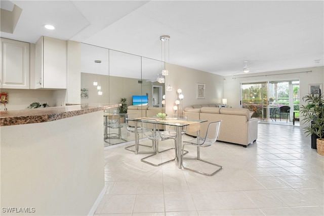 tiled dining space with ceiling fan