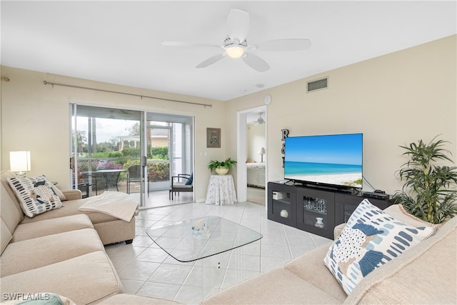 tiled living room featuring ceiling fan