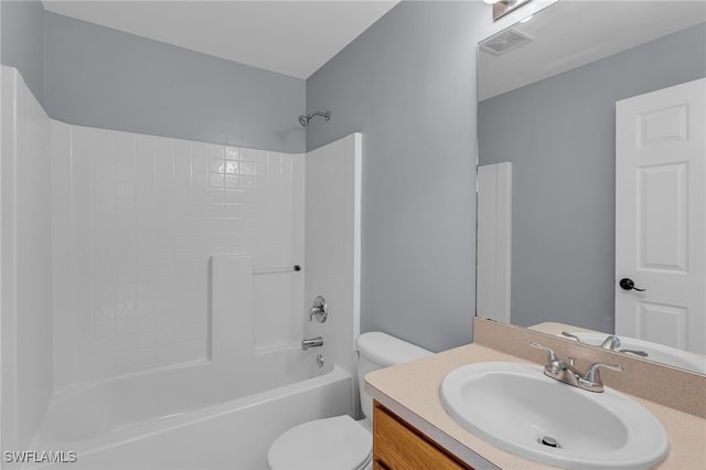 full bathroom featuring washtub / shower combination, vanity, and toilet