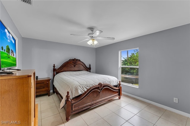 tiled bedroom featuring ceiling fan