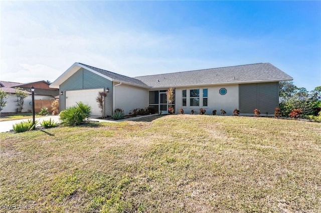 ranch-style home with a garage and a front lawn