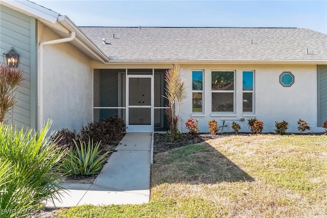 property entrance featuring a lawn