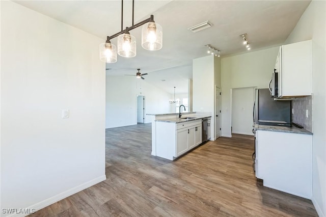 kitchen featuring hardwood / wood-style floors, sink, ceiling fan, decorative light fixtures, and white cabinetry