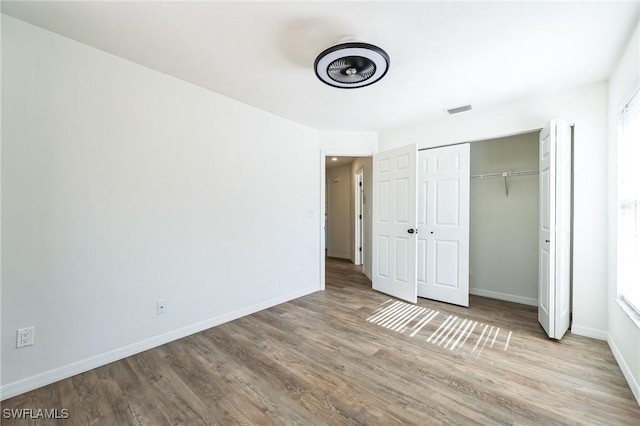 unfurnished bedroom featuring light wood-type flooring and a closet