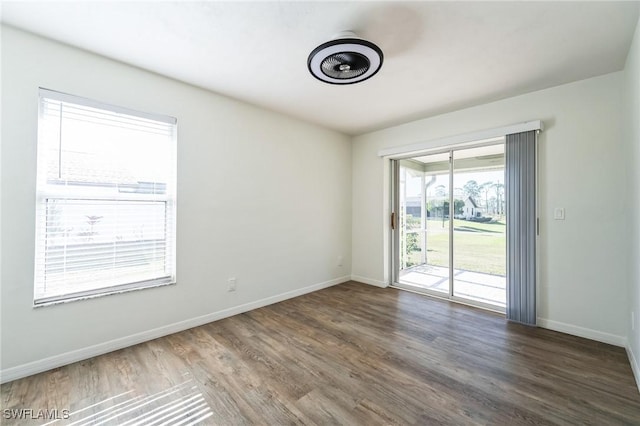 spare room with dark wood-type flooring